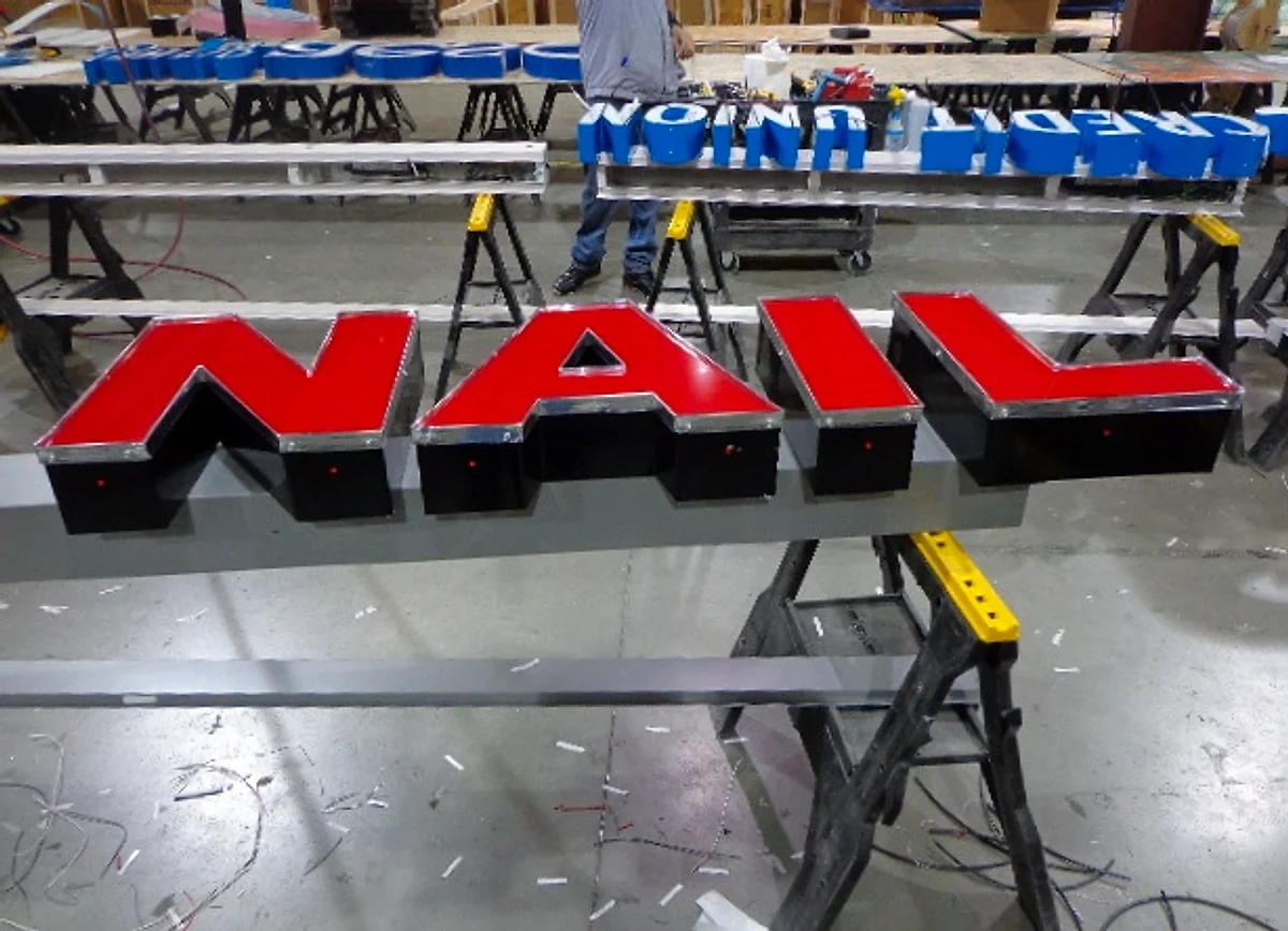 Front-lit channel letters under construction on the bench at the Tango Signs production shop