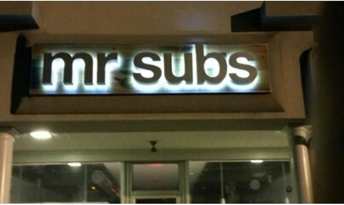 Backlit channel letters reading “mr subs” glowing above a storefront entrance, built by Tango Signs
